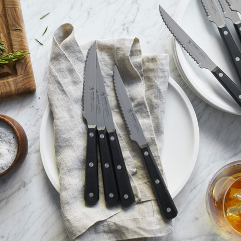 Eight-piece knife set displayed on kitchen counter for entertaining.