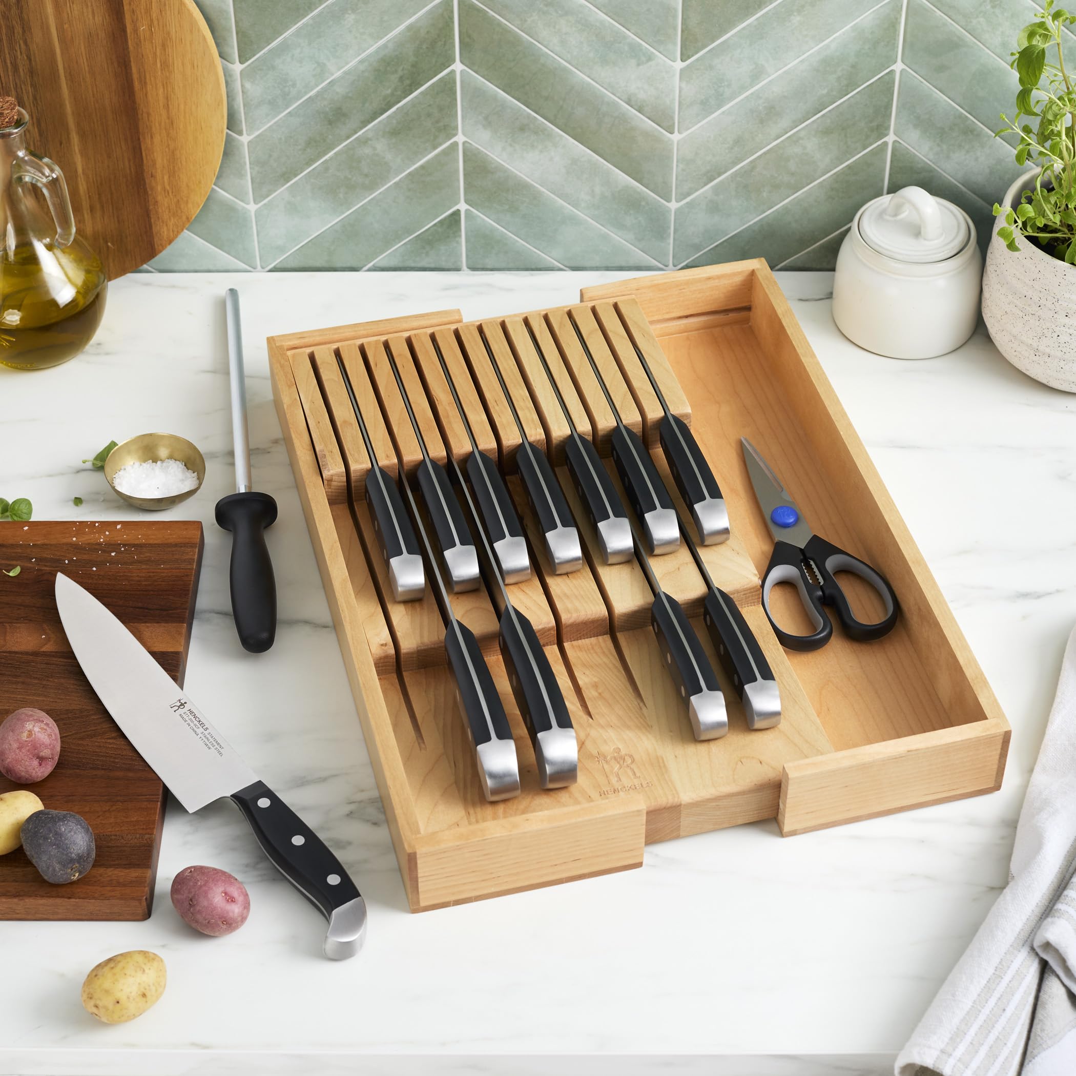 Henckels Statement 7-inch Santoku with grantons reduces sticking during mincing.