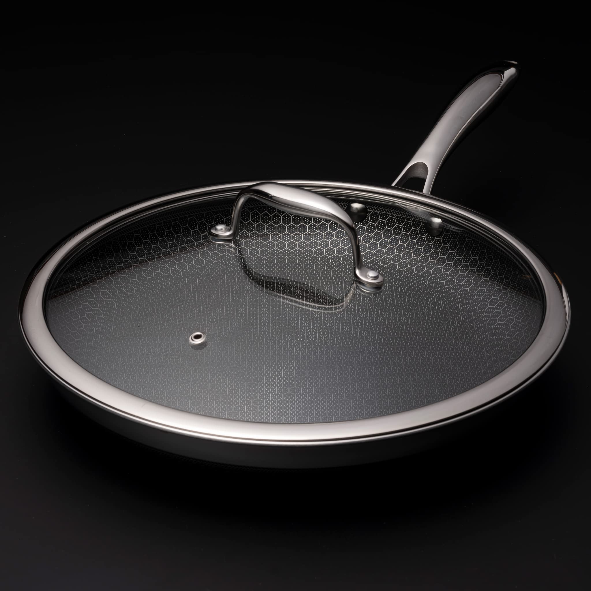 HexClad 12-inch lid on pan showing steam vent for monitoring.