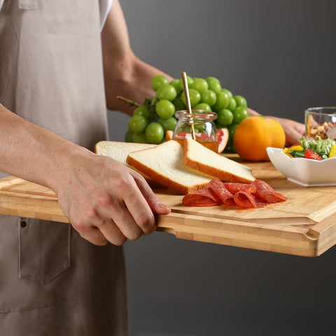 HIWARE cutting board doubles as stove-top cover for extra counter space