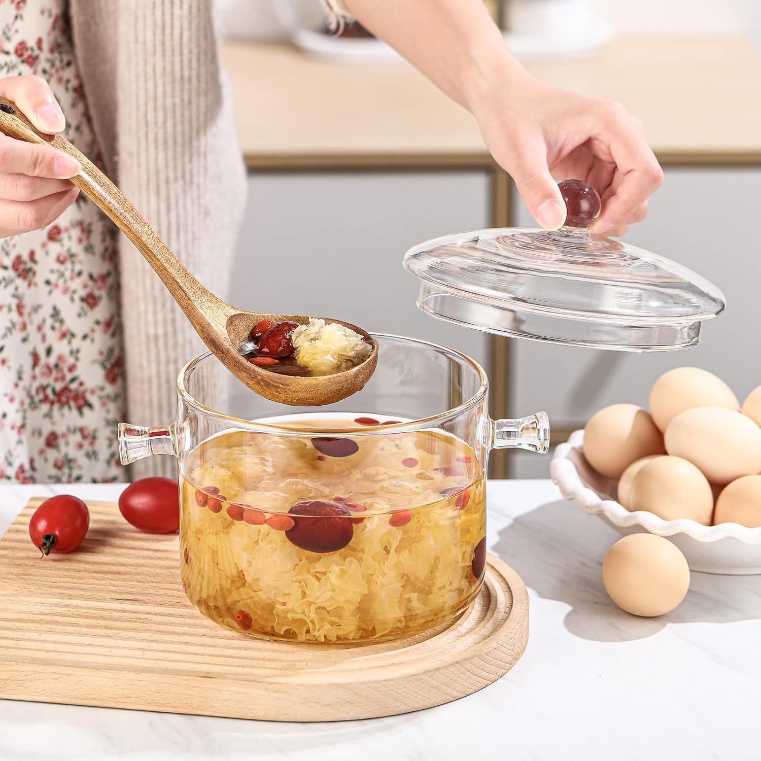 HOLIBAN clear glass pot sitting on ceramic stove, suitable for diverse heat sources.