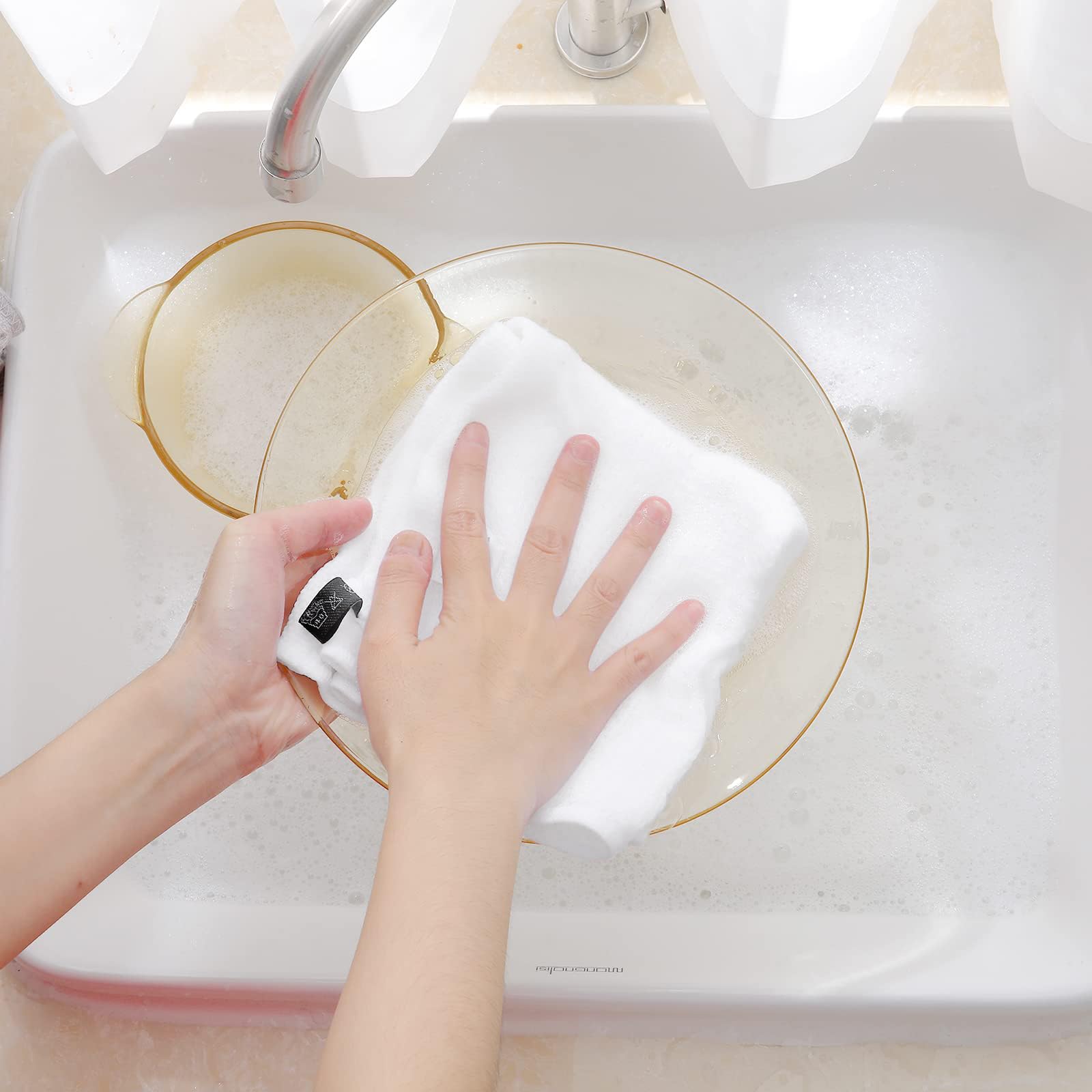 Dishcloths absorbing a spill, demonstrating quick-dry capability.