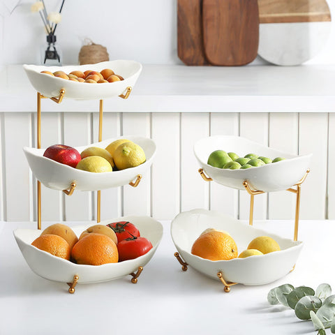 HOMKULA gold metal stand elevates the ceramic bowls with a modern touch.