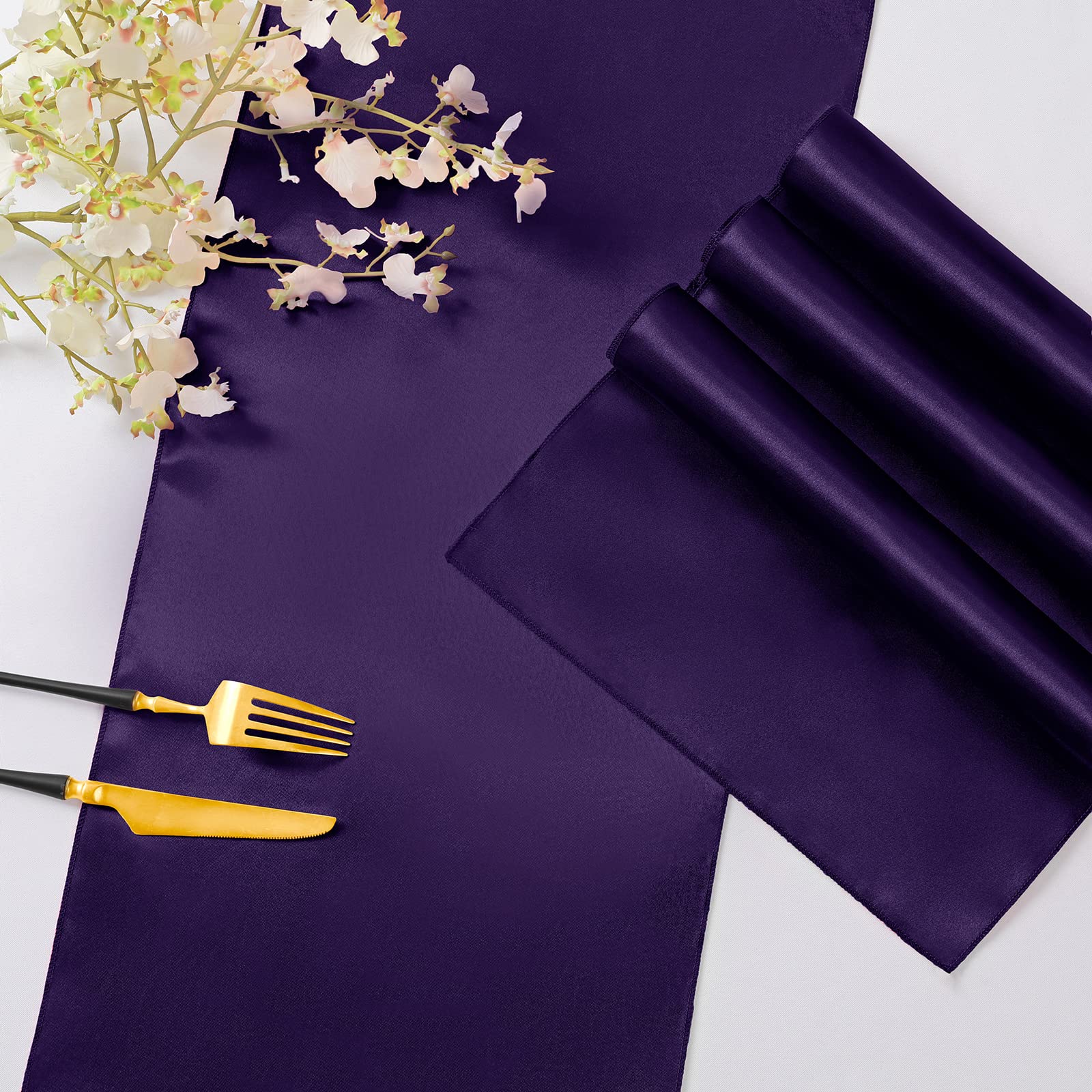 Horbaunal purple satin table runner tied in a bow as chair decor.