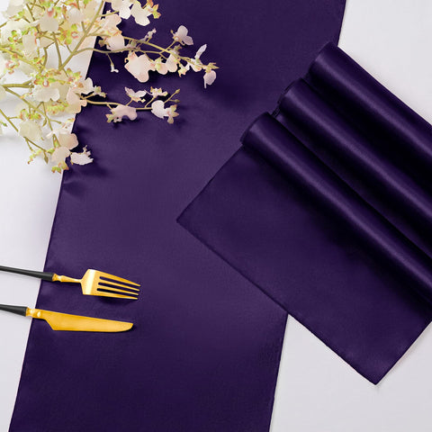 Horbaunal purple satin table runner tied in a bow as chair decor.