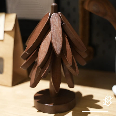 Foldable tree trivet doubles as a pot holder for hot dishes.
