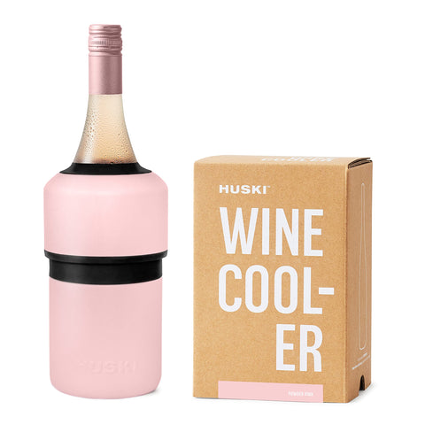 Huski Wine Chiller Pink exterior on table keeps wine cold with stylish presence