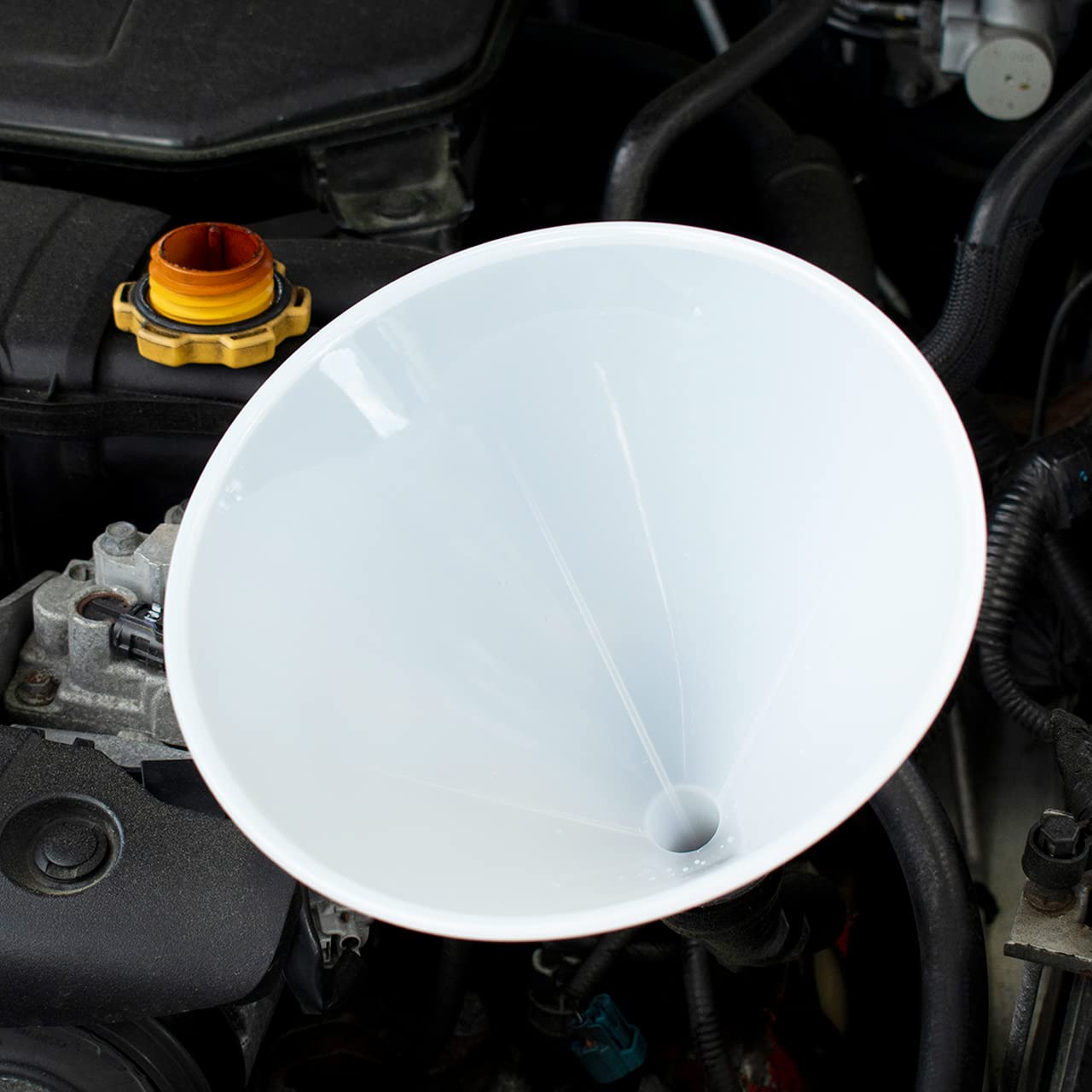 Hutzler funnel with side ribbing vents air for spill-free pouring.