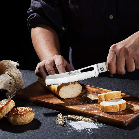 Huusk folding bread knife open for even bread slicing with a wide edge.