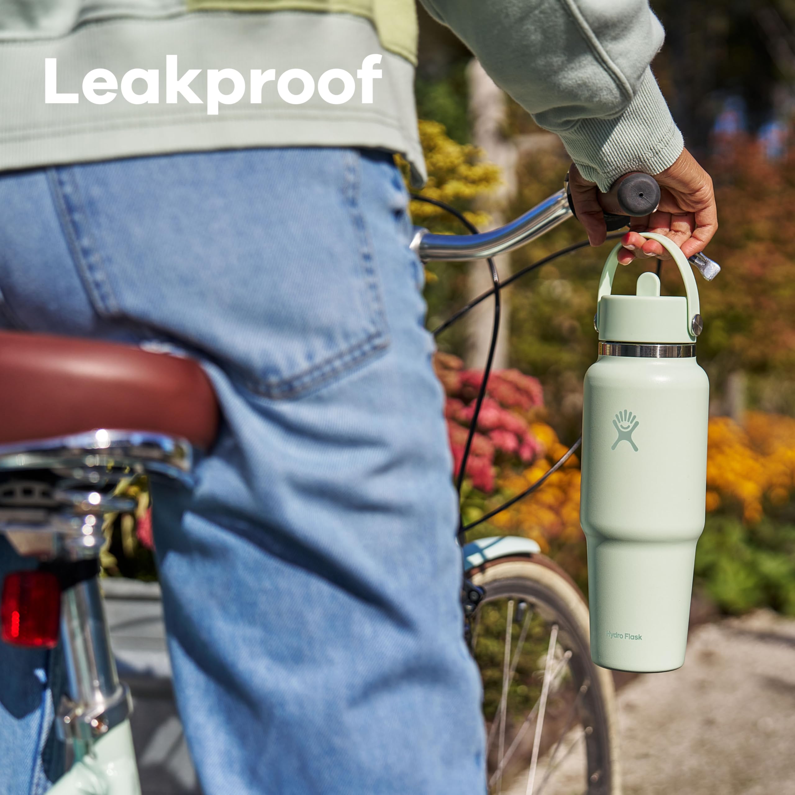 Hydro Flask Travel Bottle 32oz Ivory with ice cubes demonstrates ice-friendly capacity.