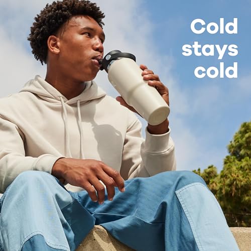 Hydro Flask Travel Bottle demonstrates cupholder-fit design for easy on-the-go sipping.