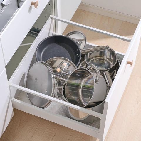 IKEA Variera lid organizer being wiped clean with a damp cloth