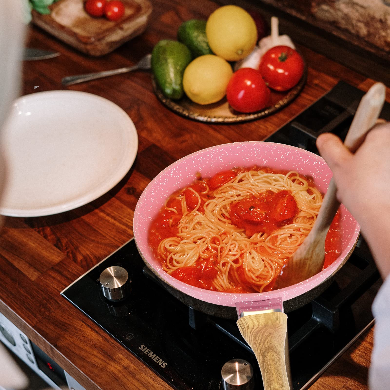Innerwell pink egg pan on stove for versatile cooking on gas, electric, or ceramic.