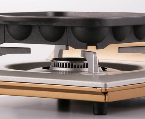 Iwatani Takoyaki grill pan bottom view emphasizes heat retention for even browning.