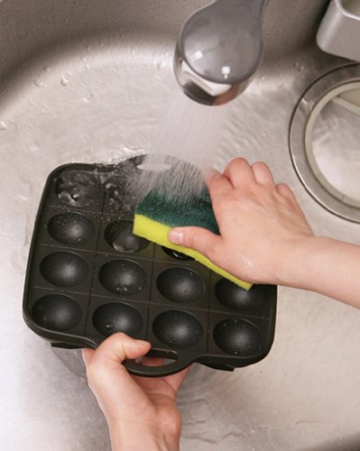 Iwatani Takoyaki grill pan coating close-up highlights durable aluminum alloy construction.
