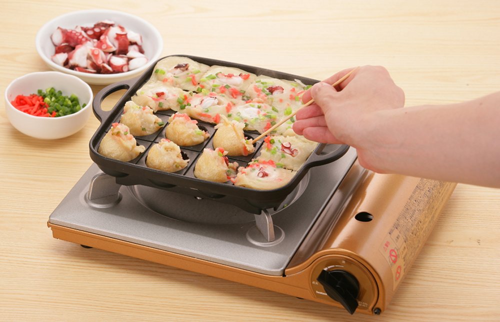 Iwatani Takoyaki grill pan handle close-up for secure grip during cooking.