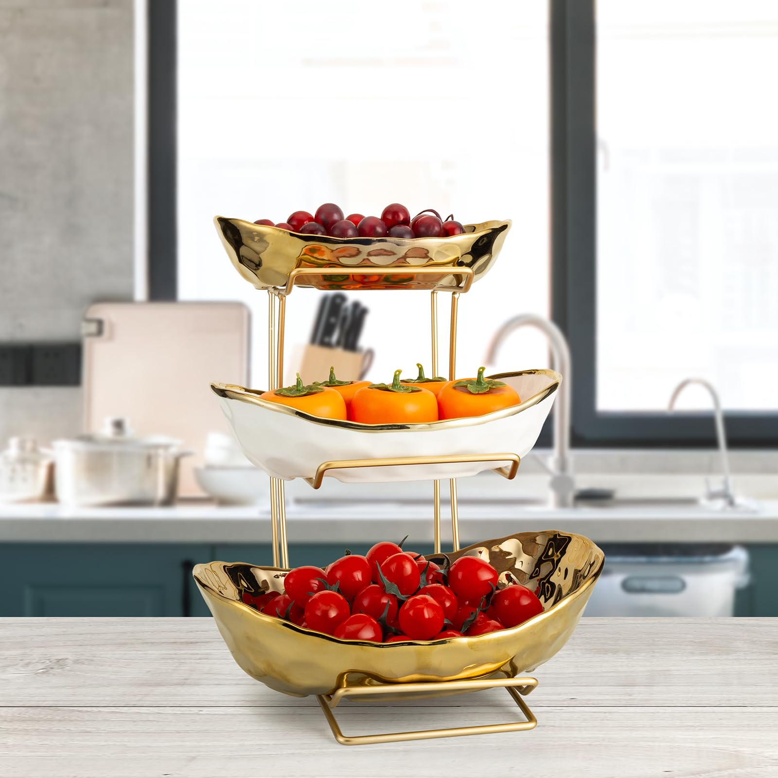 Jessie 3-tier ceramic fruit bowl with gold stand viewed from the side for elegant display.
