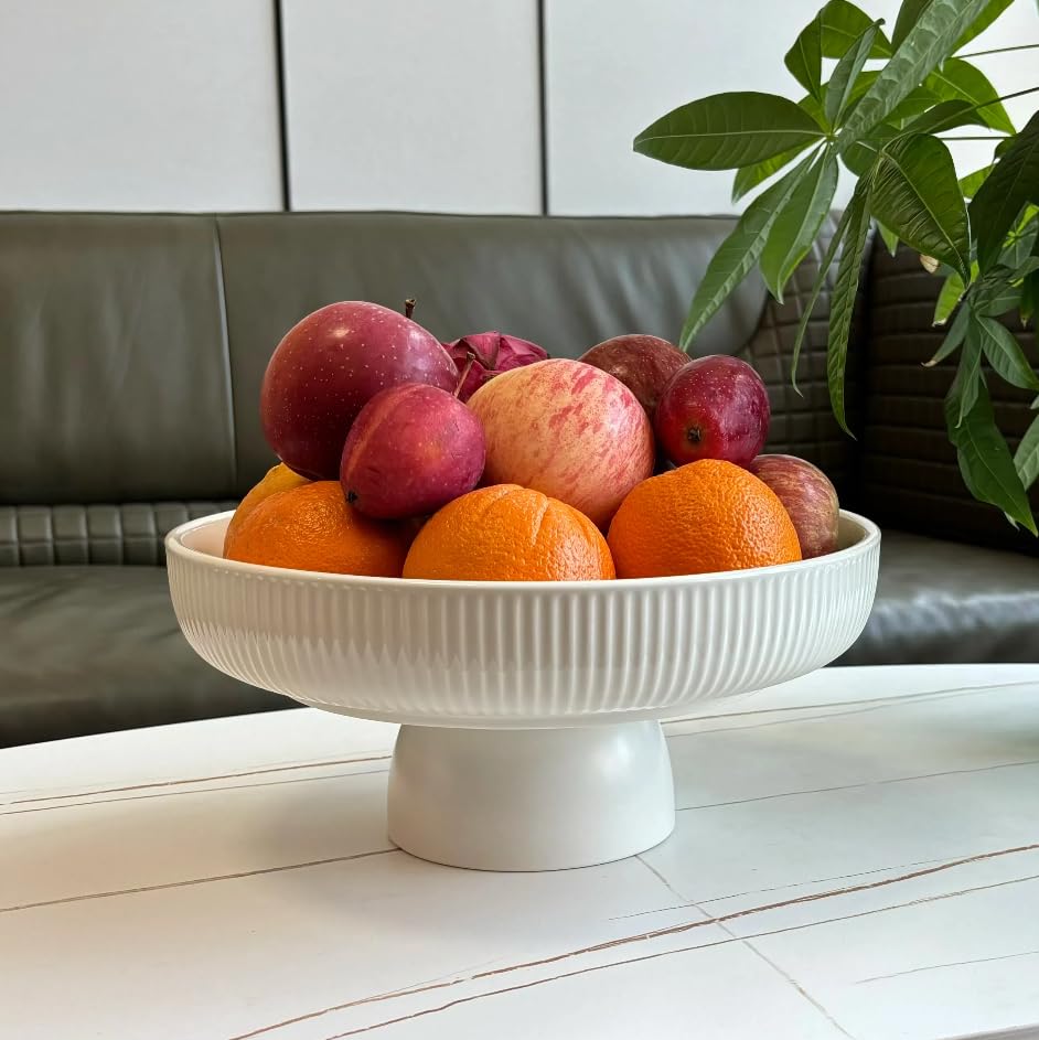JolieJulie ceramic fruit bowl on counter with fresh fruit, a stylish centerpiece.