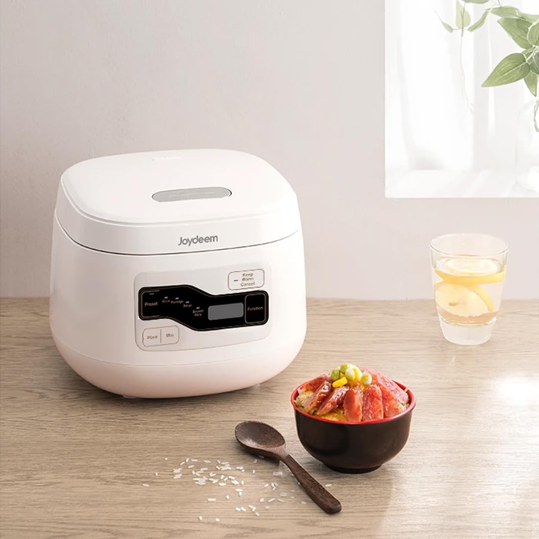 Joydeem compact 2L rice cooker on a kitchen counter in a small-space setup.