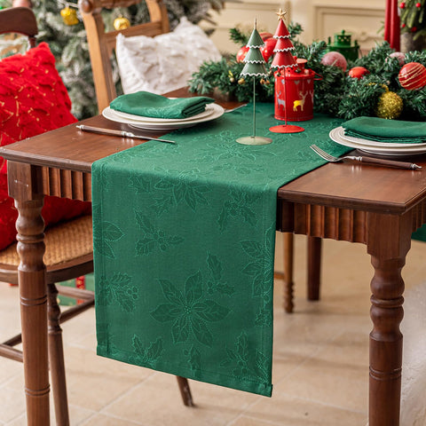 Joyfol Day Christmas table runner with green poinsettia weave enhances holiday tables