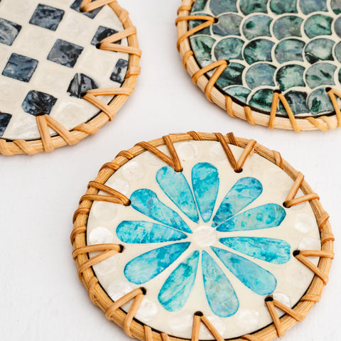 Jungle Culture rattan trays complement the coasters for cohesive coastal decor.