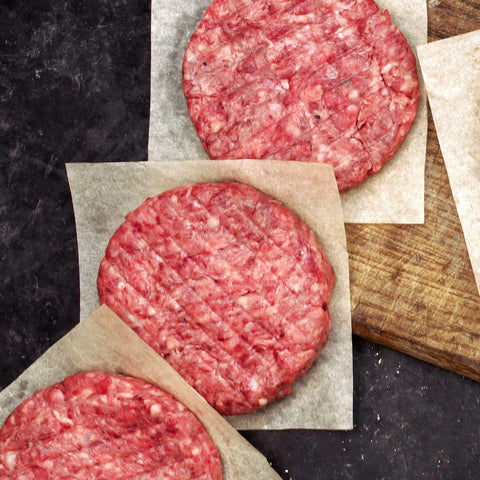 Juvale parchment sheets keep hamburger patties separated, preventing sticking during prep.