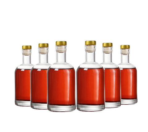 Kaachli clear glass bottle front view for portable 6 oz servings.