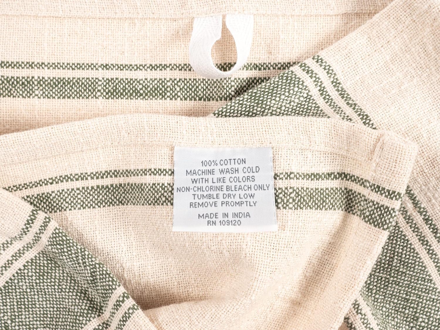 KAF Home olive slubbed kitchen towel drying hands after washing dishes.