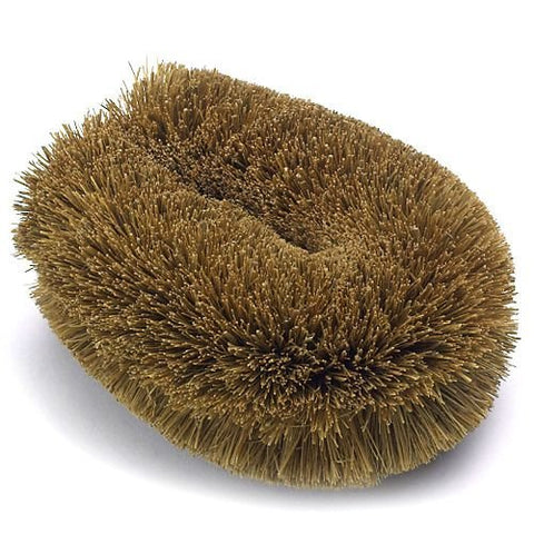 Kamenoko Tawashi scrub brush in use on cookware for durable cleaning.