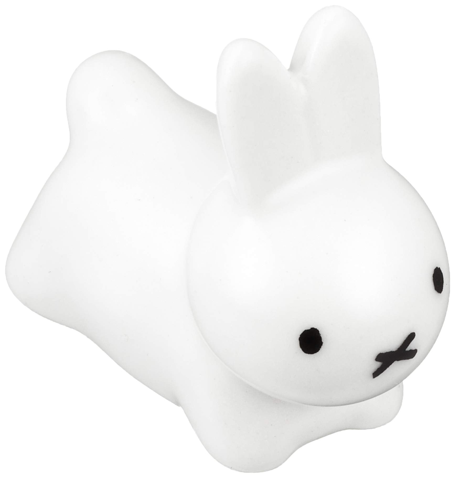 Kaneshotouki Miffy rabbit chopstick rest in white porcelain holding chopsticks.