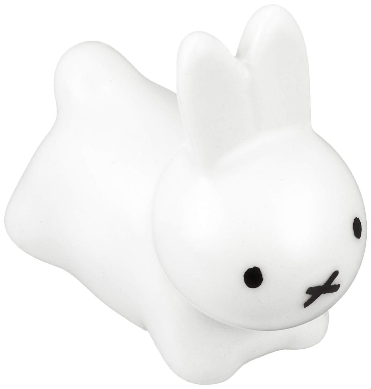 Kaneshotouki Miffy rabbit chopstick rest in white porcelain holding chopsticks.