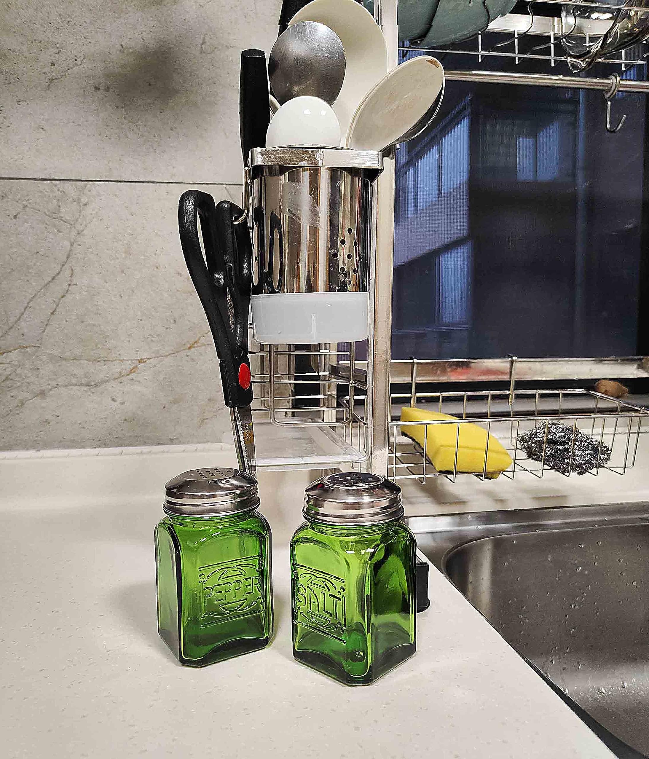 Kerixi green glass shakers shown being filled easily for quick seasoning.
