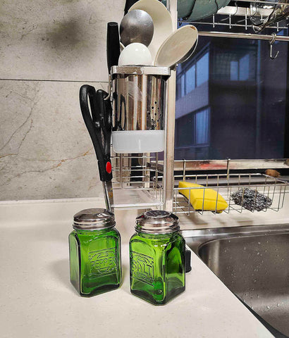 Kerixi green glass shakers shown being filled easily for quick seasoning.
