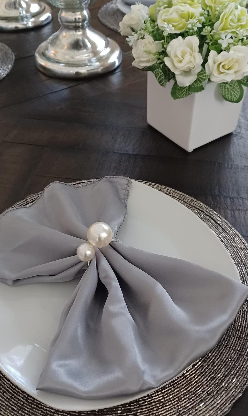 Kesote Christmas table with pearl napkin rings completing festive look.