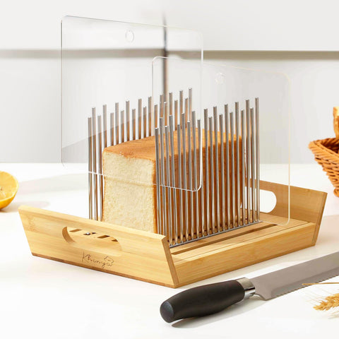 KHINYA bread slicer with boat-shaped tray catching crumbs and serving slices