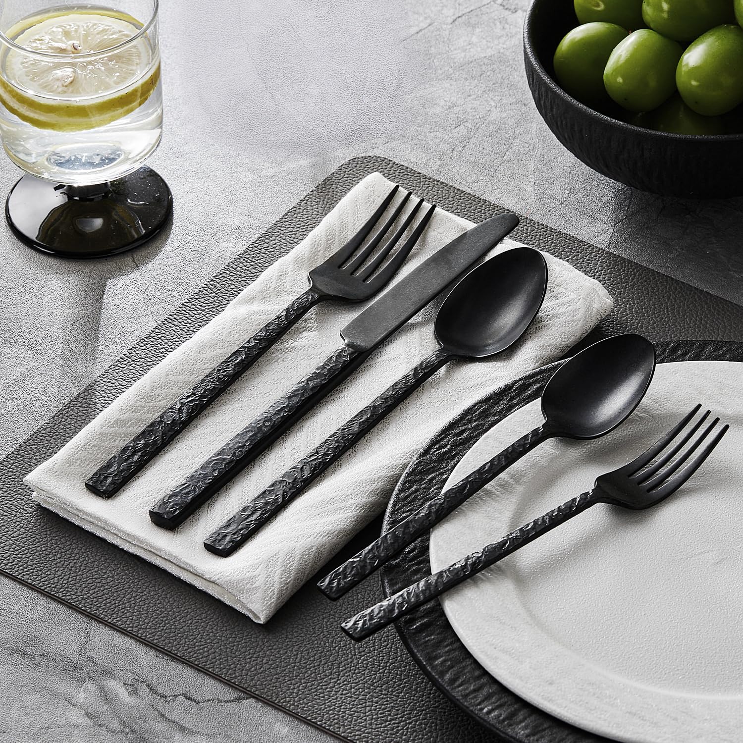 Kingstone closeup showing the shiny finish of black hammered flatware.