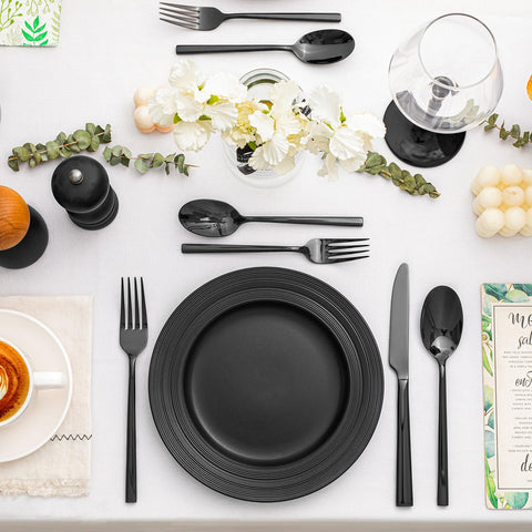 Kingstone black silverware service for 8 set arranged at table.