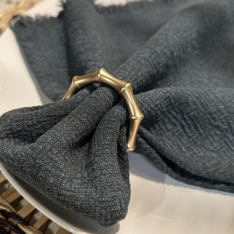 Close-up of Kintyno rings showing matte gold finish with bamboo texture.