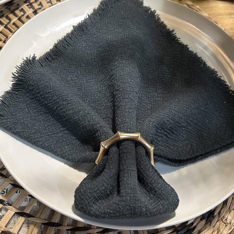 Holiday dining scene featuring Kintyno gold napkin rings with festive napkins.