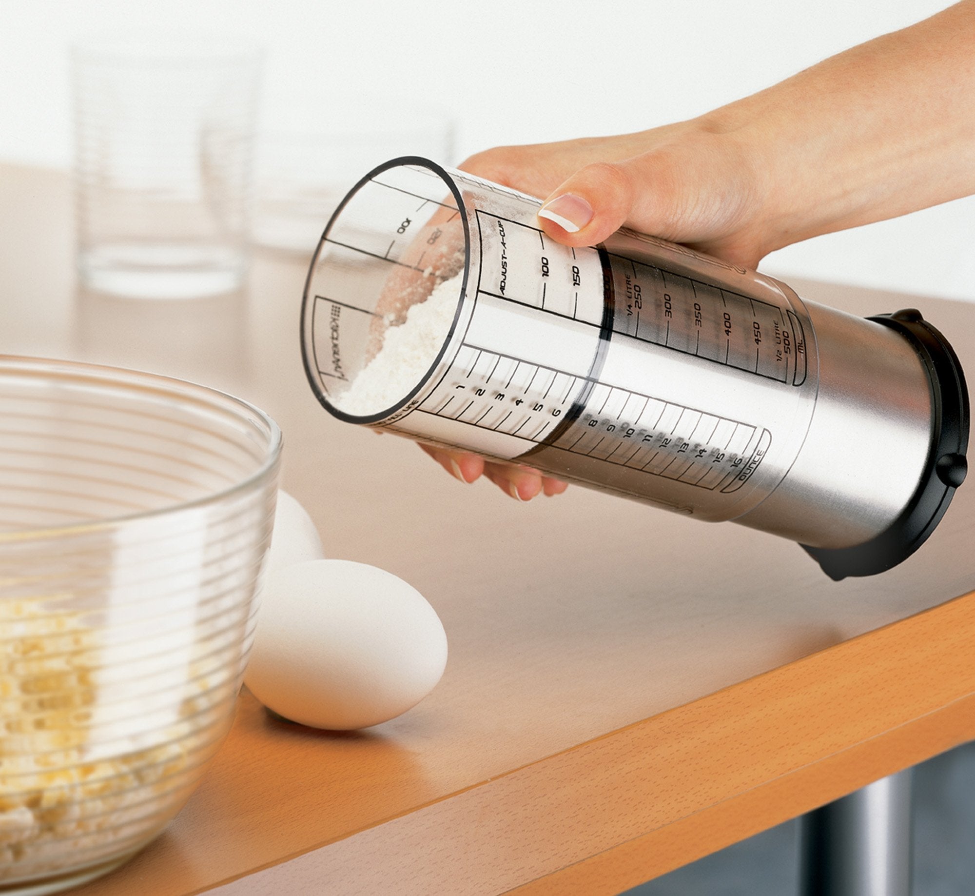 KitchenArt Pro 2-Cup Adjust-A-Cup clear measurement sleeve with metric and US units.