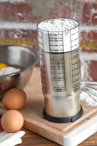 KitchenArt Pro 2-Cup Adjust-A-Cup silicone disk and plunger simplify dispensing sticky ingredients.