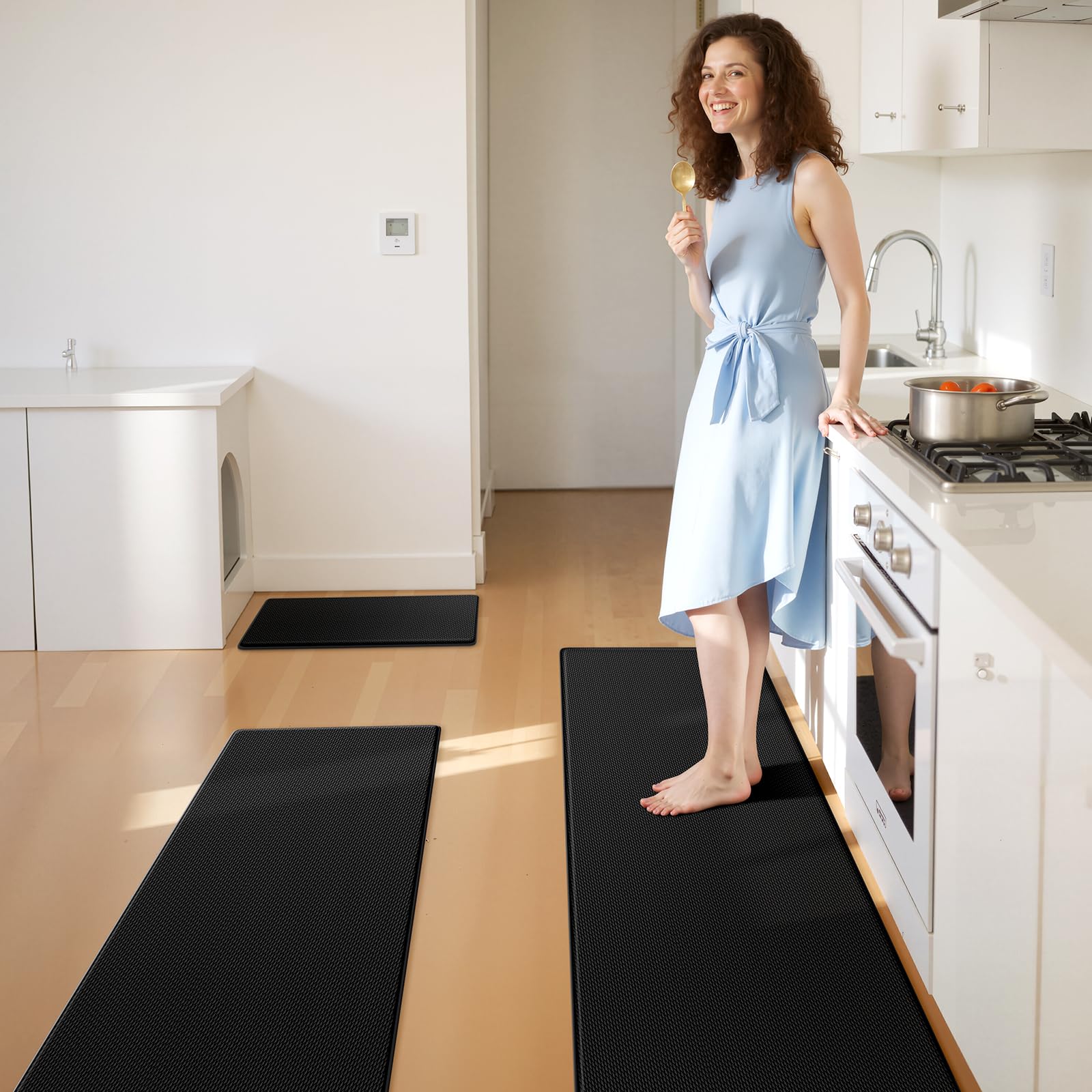 KitchenClouds waterproof sink mat protects floors around the basin.
