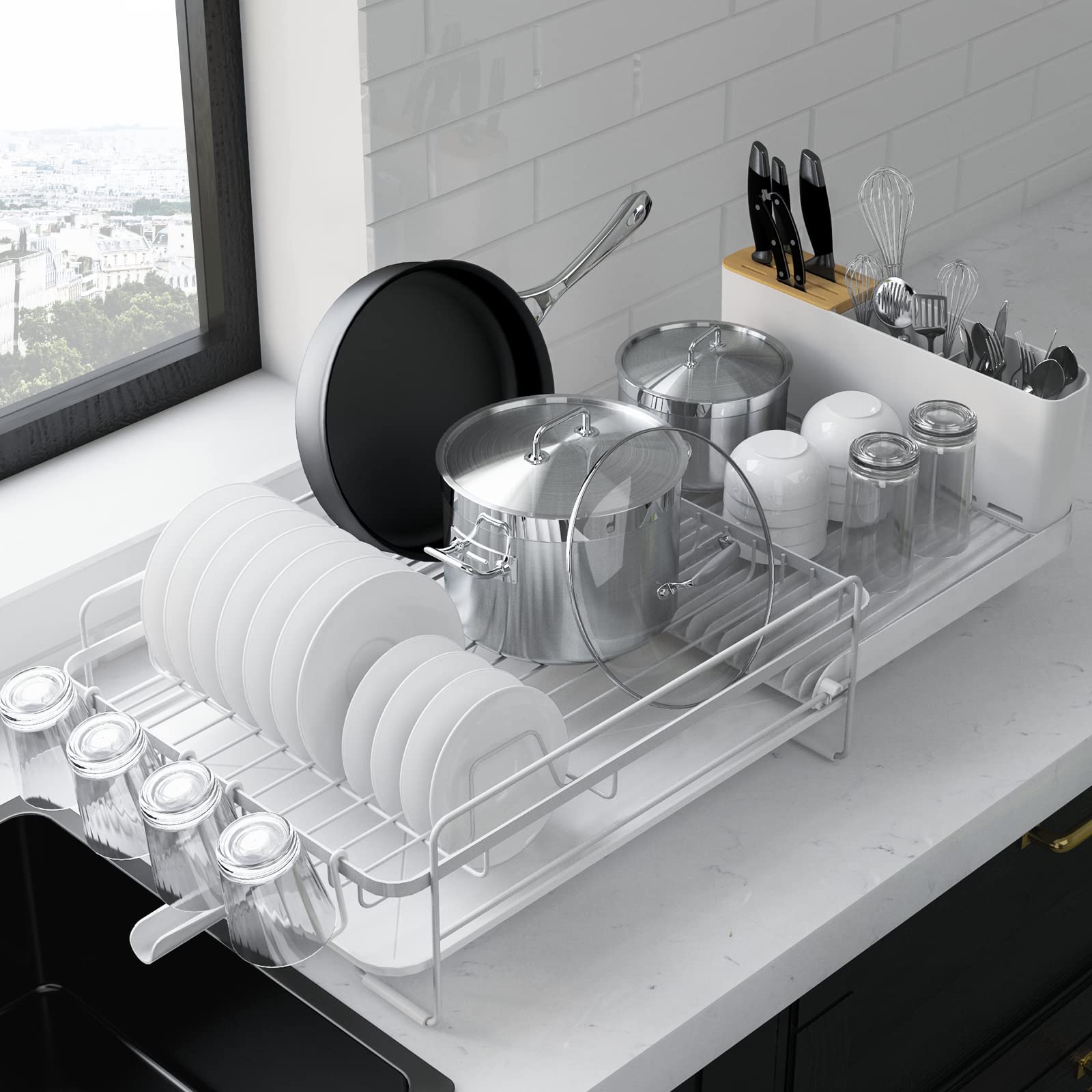 Kitsure extendable dish drying rack on a kitchen counter, adjusts length for compact spaces.