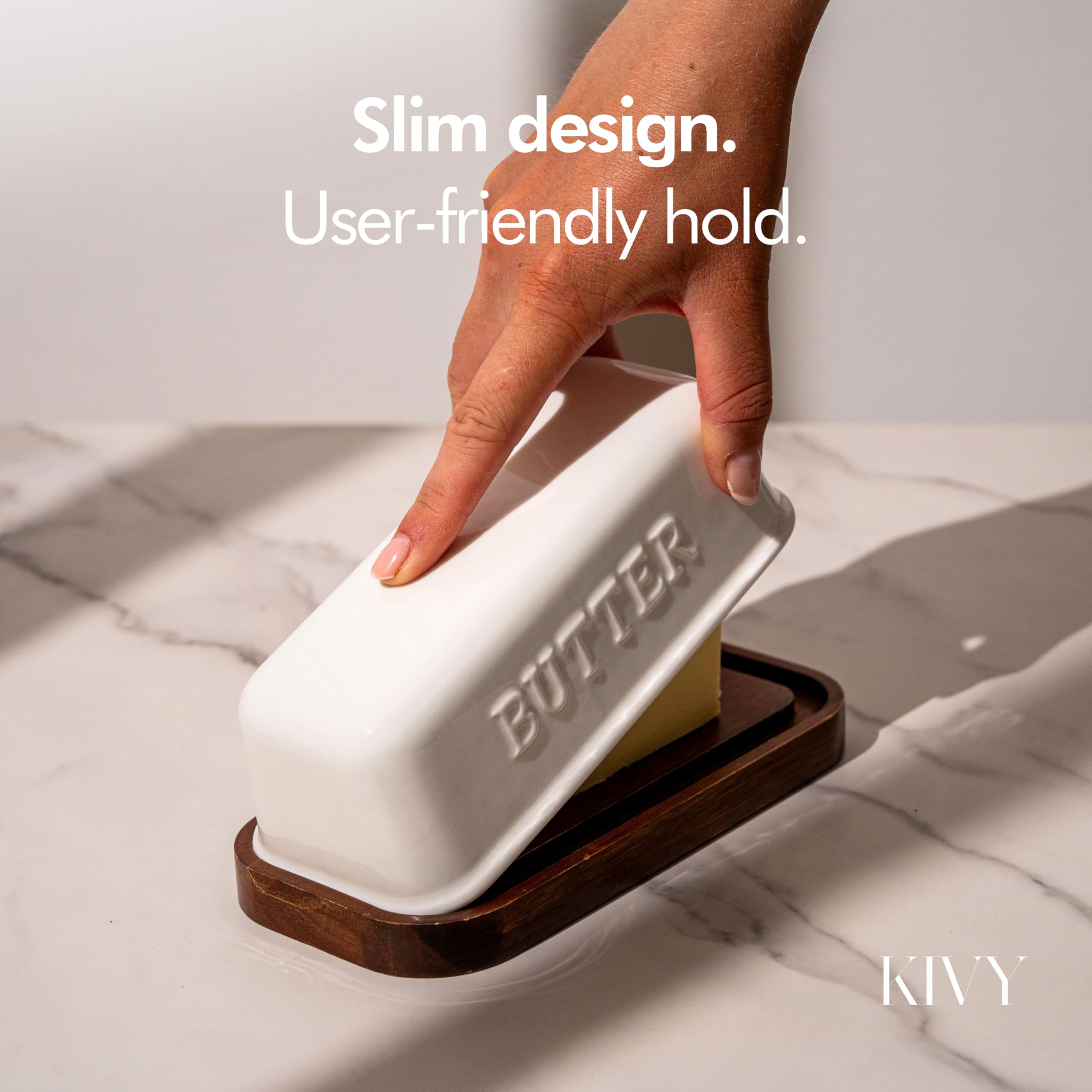 Sleek, modern KIVY butter dish with FSC-certified wood base in a kitchen setting.