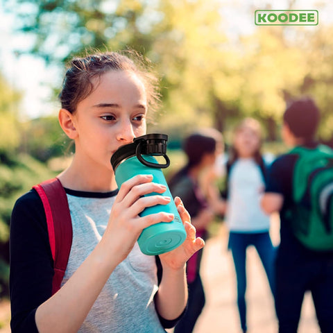 koodee teal 16 oz bottle in a school setting ready for class