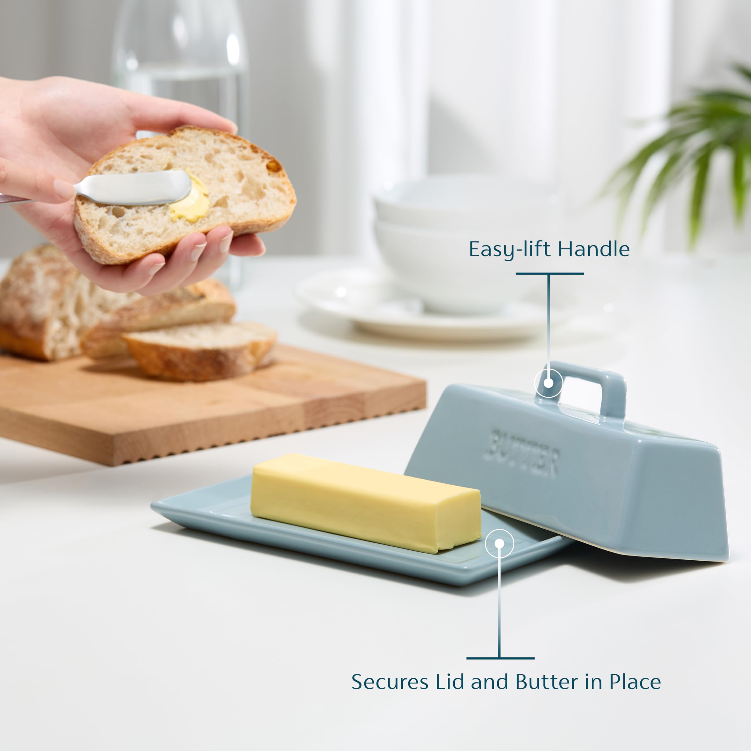 KooK butter dish lid being lifted for quick butter access.