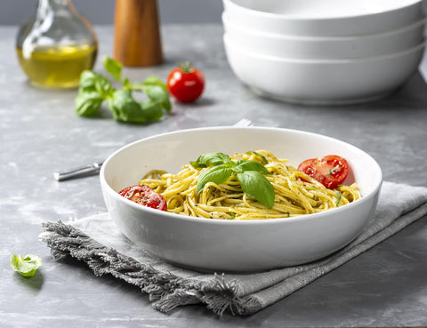 Kook serving bowl white on table highlights versatile use for meals and entertaining.