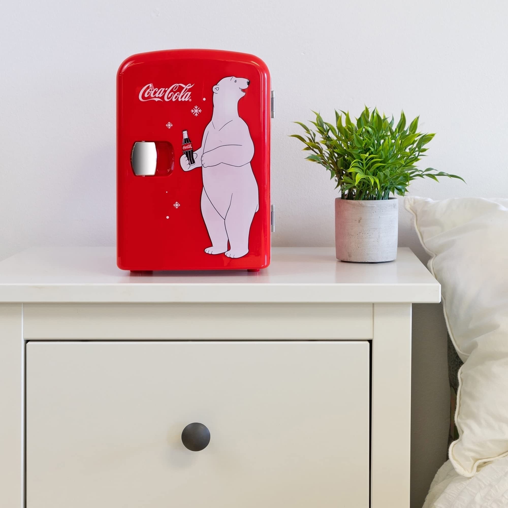 Interior shelf of Koolatron Coca-Cola Polar Bear mini fridge enables flexible organization.