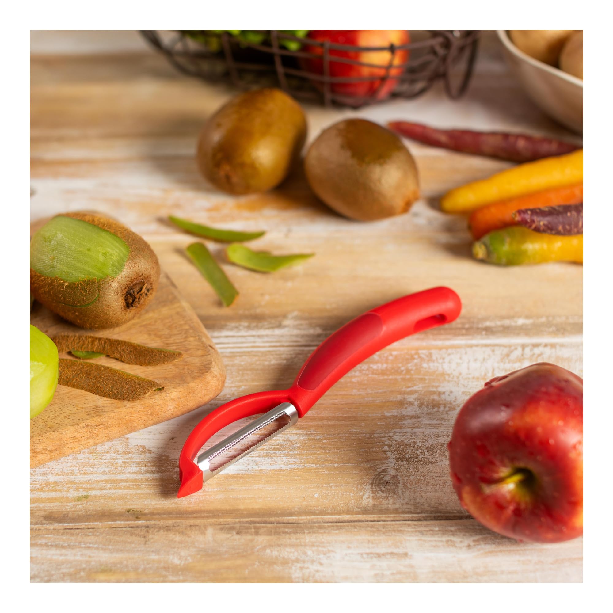 Kuhn Rikon Piranha Swivel Peeler red handle for comfortable grip.