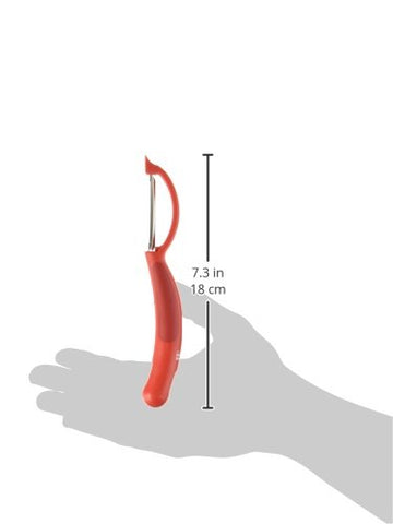 Kuhn Rikon Piranha Swivel Peeler in use, peeling a smooth-skinned fruit quickly.